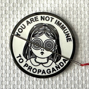 Propaganda Needle Minder